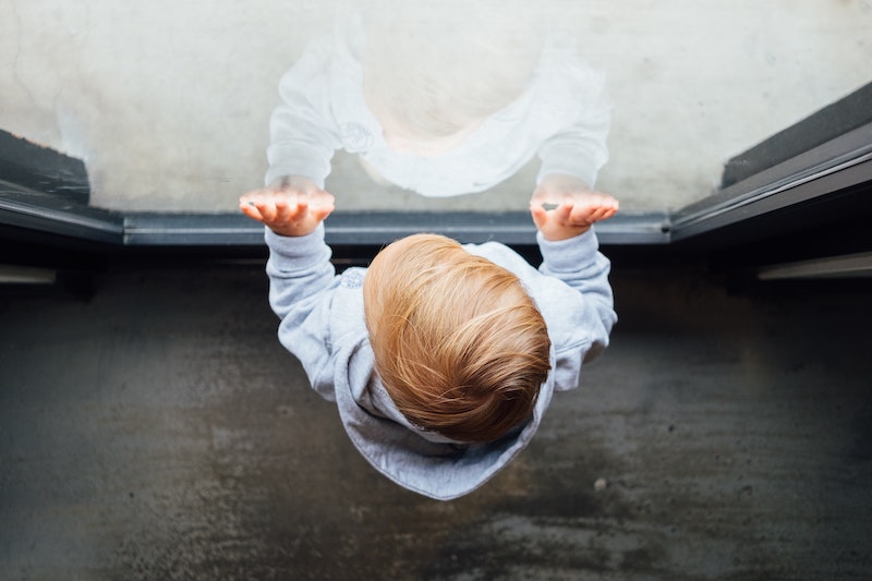 baby standing at window