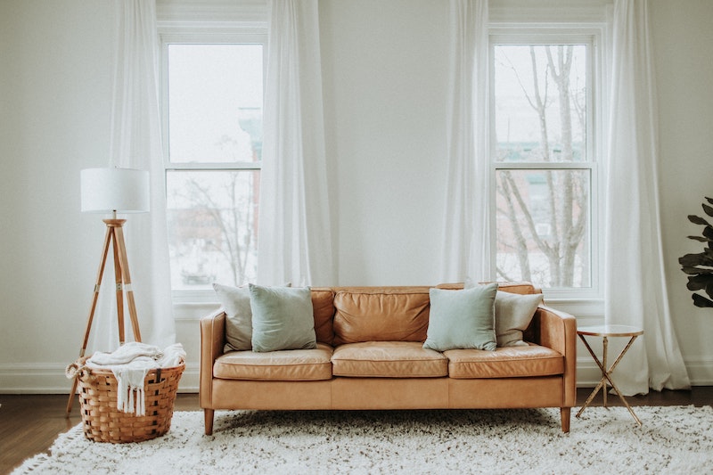 minimalist living room with brown couch and lamp